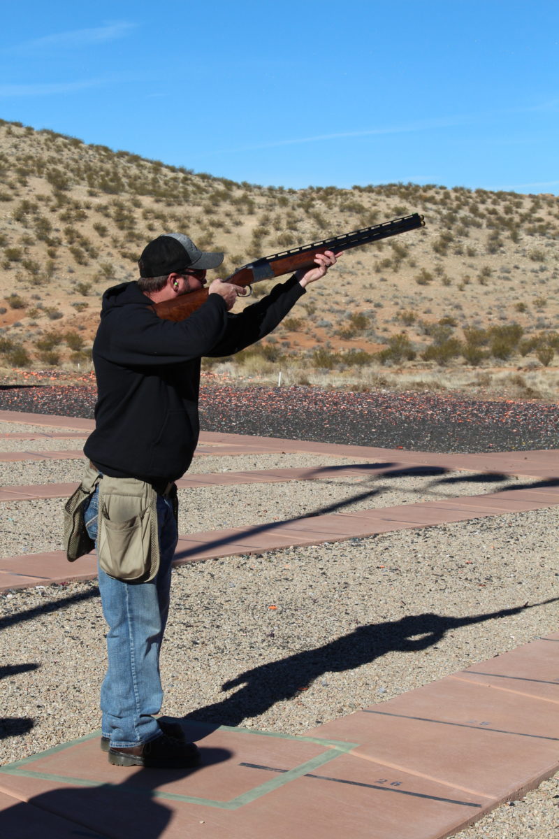 Man in Cap Aiming Shotgun