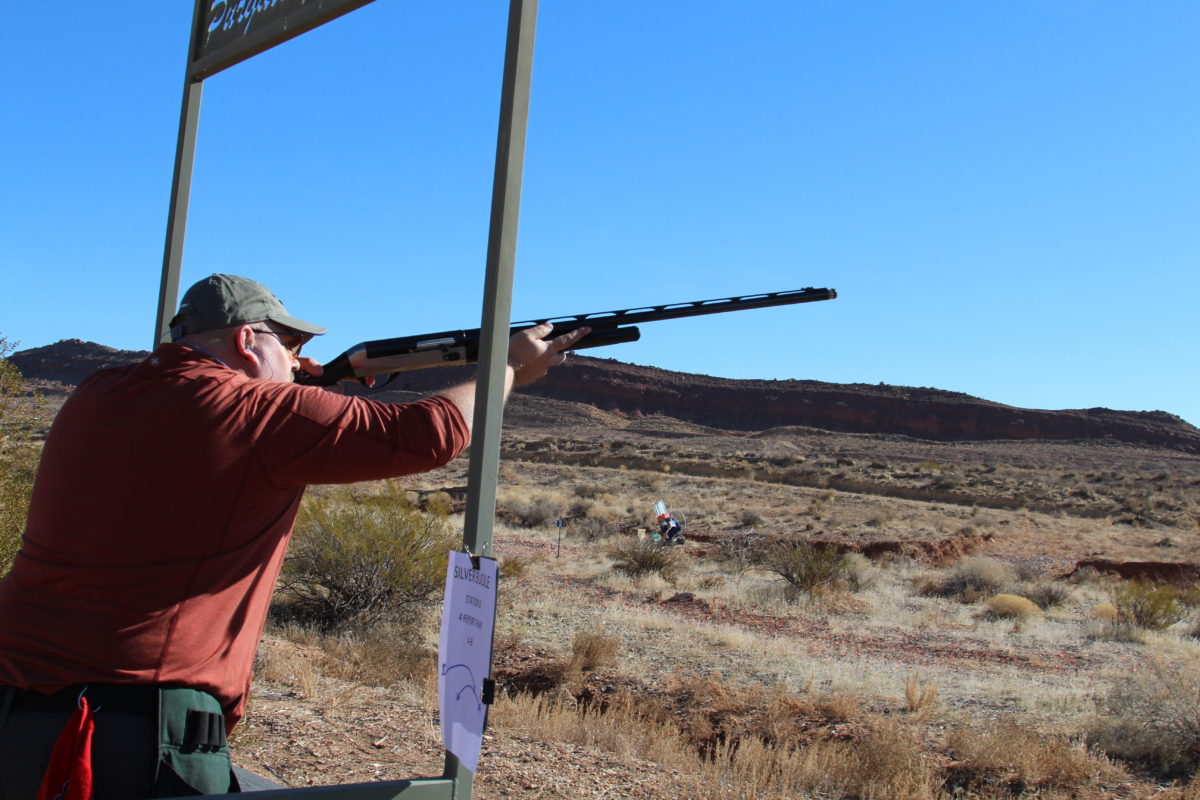 Man with Shotgun Aiming into the Distance